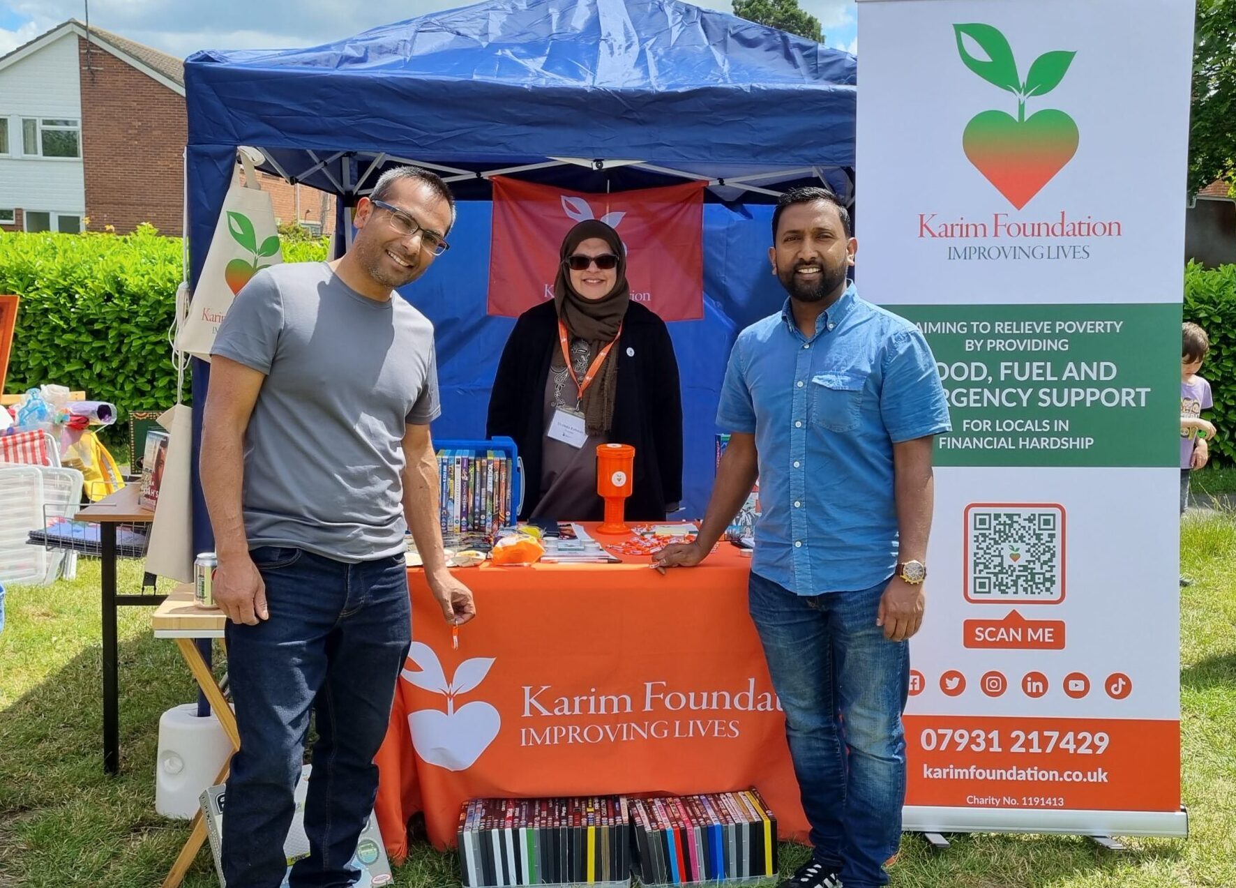 Two visitors standing in front of the Karim Foundation stall at the Arbury Carnival in 2022.