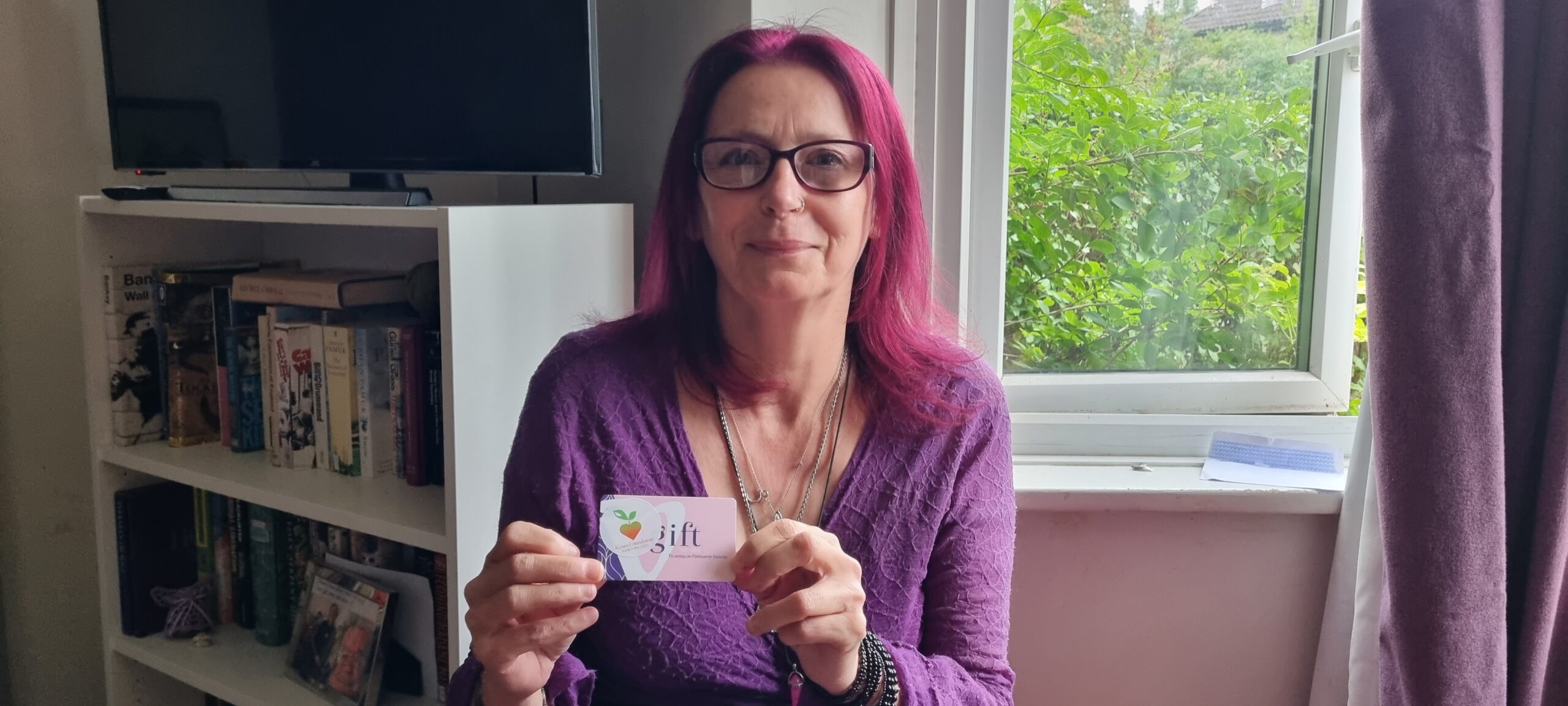 Asa Benstead is the winner of the Karim Foundation's Free Prize Draw, held at the 2023 Arbury Carnival. She is holding a Patisserie Valerie gift card.